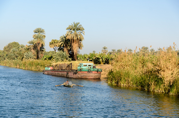 Fishermen And Cargo Ship Along The Bank Of The Nile